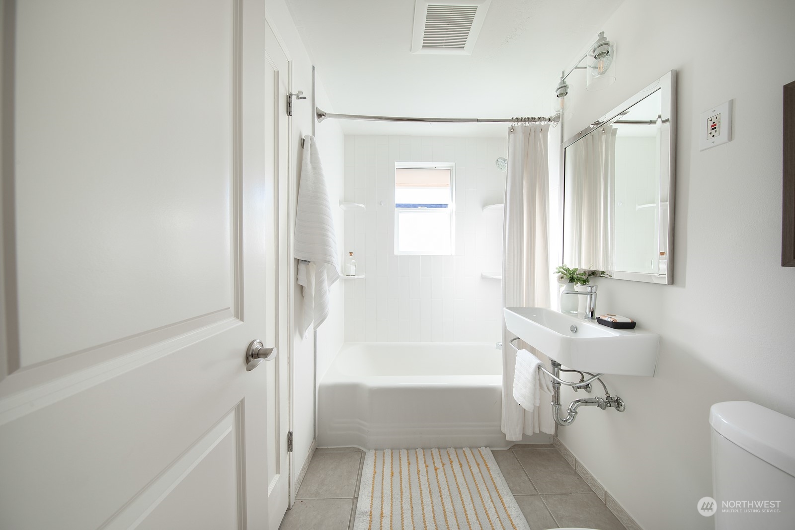 1821 North 80th Street Seattle, WA 98103 - Photo 10 of 30 a bathroom with a sink a toilet and shower
