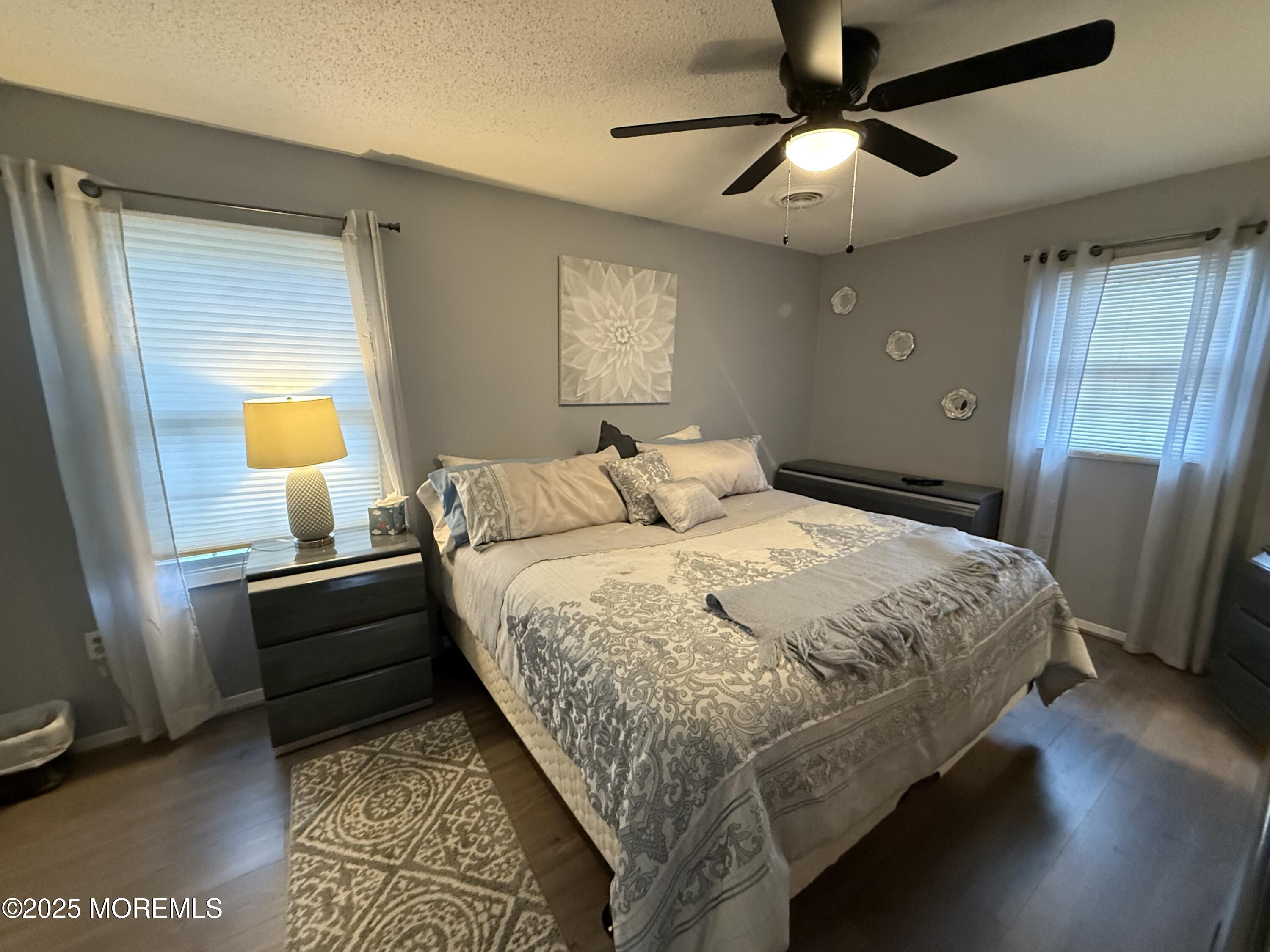 4 Hemlock Hill Road Jackson, NJ 08527 - Photo 17 of 42 a bedroom with a bed and a chandelier