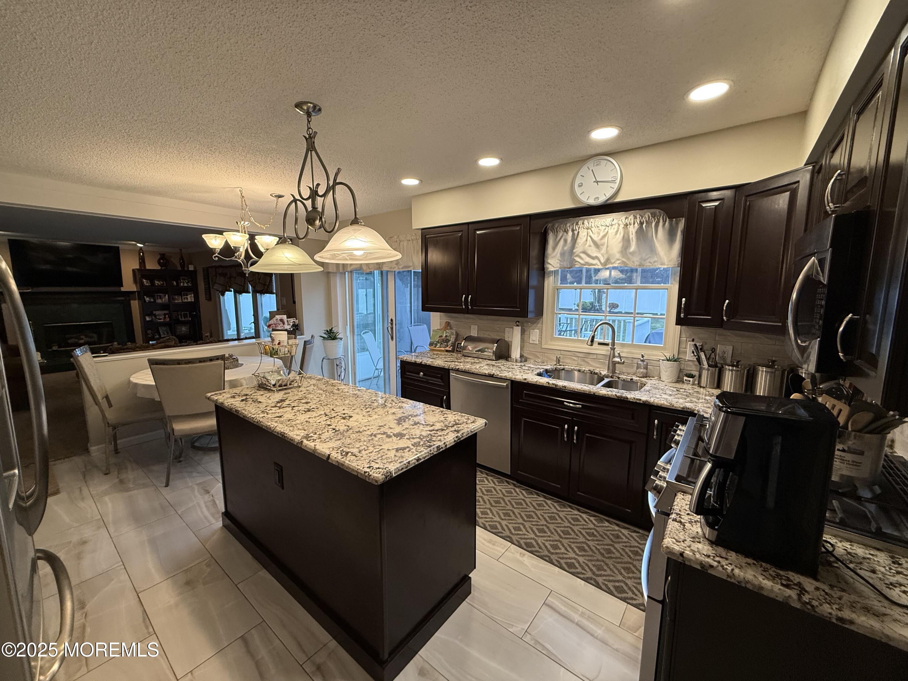4 Hemlock Hill Road Jackson, NJ 08527 - Photo 3 of 42 a kitchen with stainless steel appliances granite countertop a stove top oven a sink dishwasher and a microwave