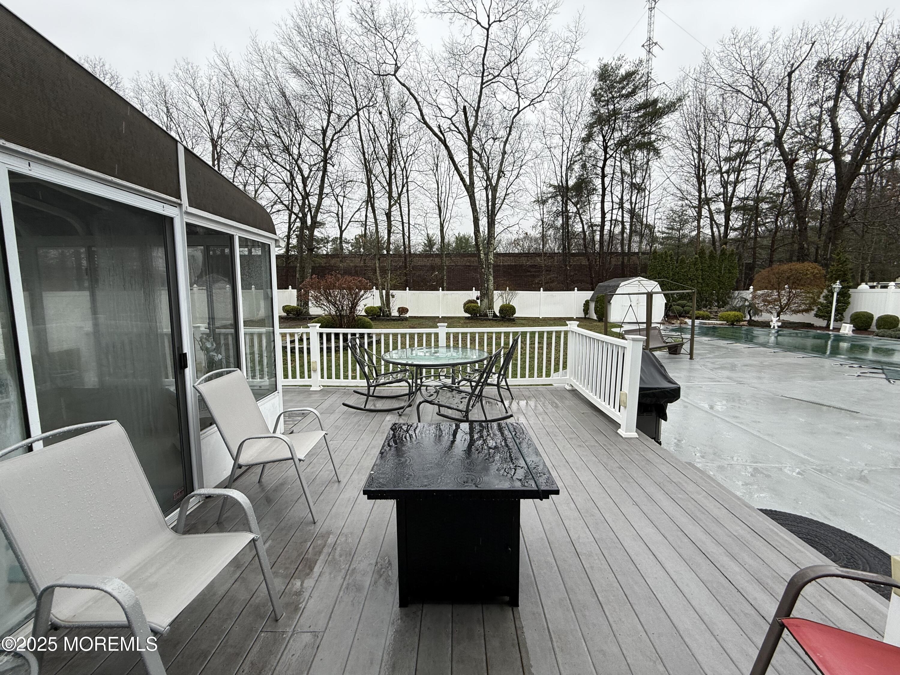 4 Hemlock Hill Road Jackson, NJ 08527 - Photo 40 of 42 a view of a patio with couches table and chairs and wooden floor