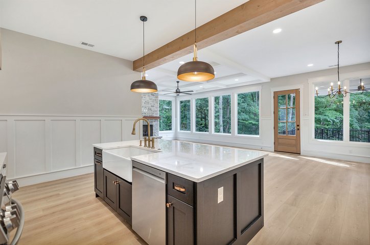 1422 Hunters Trail Anderson, SC 29625 - Photo 9 of 41 A well-appointed kitchen island with a farmhouse sink anchors this open-concept space featuring a coffered ceiling and abundant natural light.