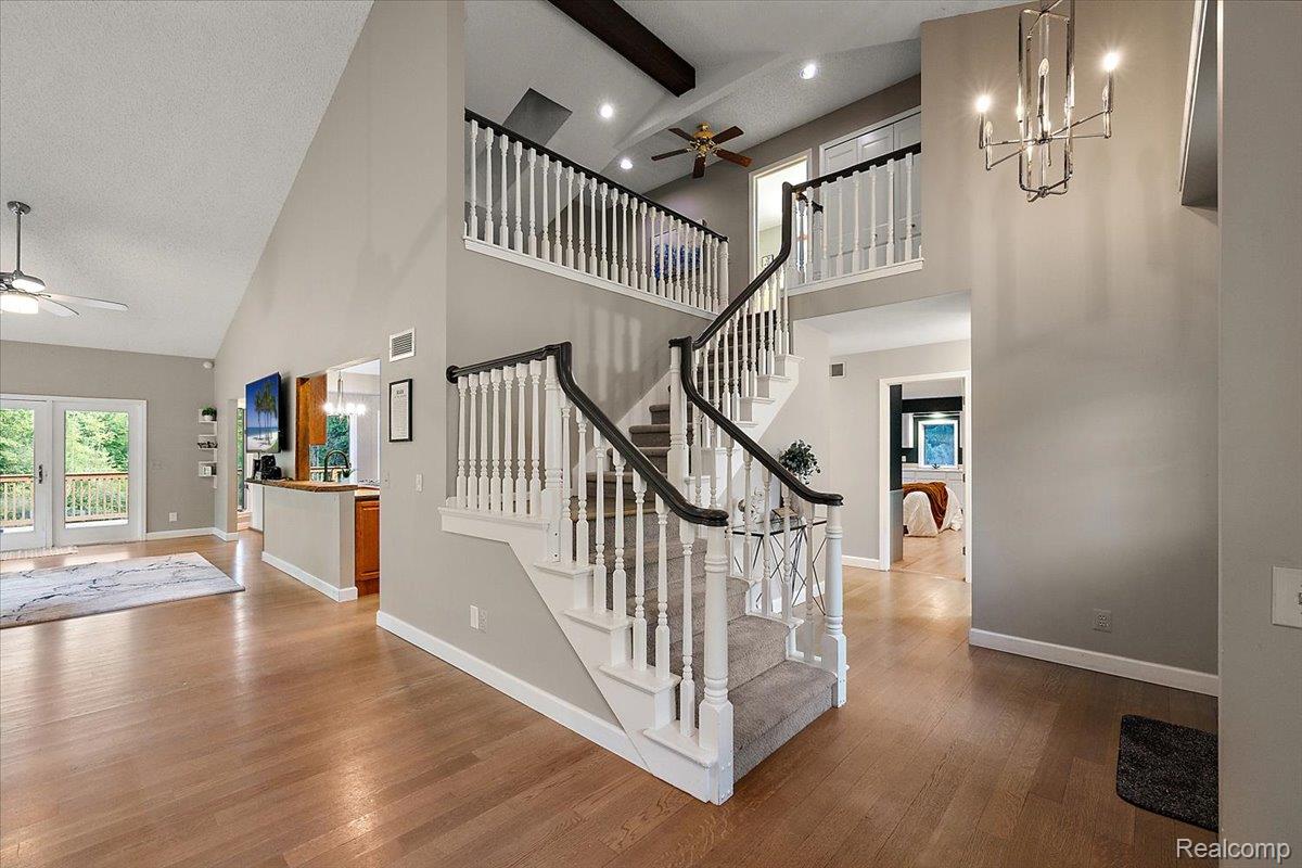 707 West Sutton Road Metamora, MI 48455 - Photo 23 of 84 Two-story foyer with a grand staircase and wood-finish flooring