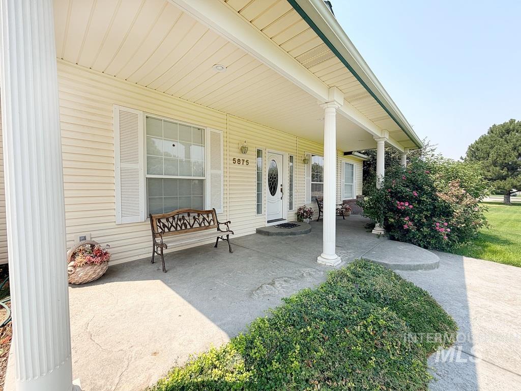 5875 Diamond Ridge Way Nampa, ID 83686 - Photo 4 of 32 Covered front porch with fluted columns and a concrete pathway