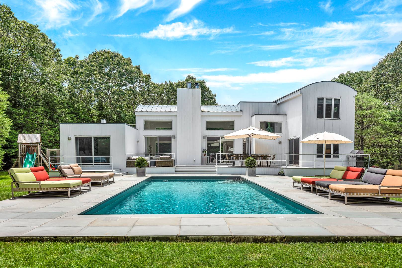 165 2 Holes Water Road East Hampton, NY 11937 - Photo 1 of 19 a front view of multiple houses with yard