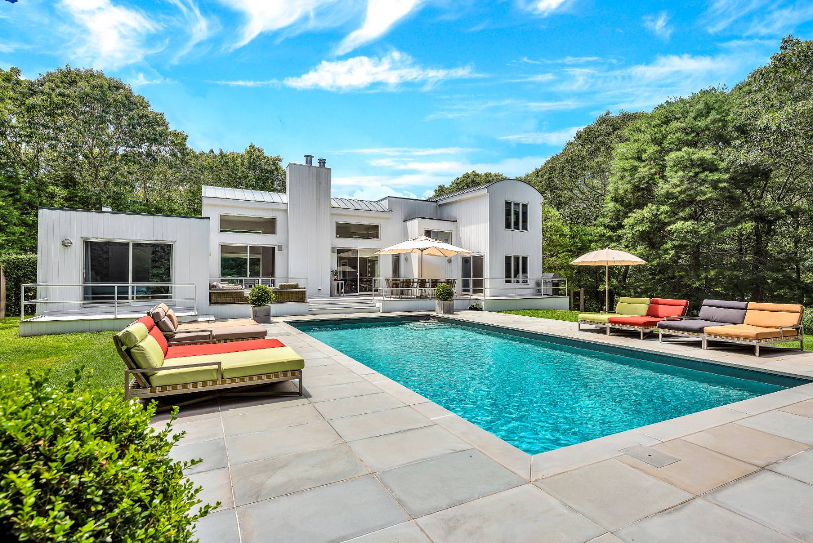 165 2 Holes Water Road East Hampton, NY 11937 - Photo 2 of 19 a front view of house with yard and swimming pool