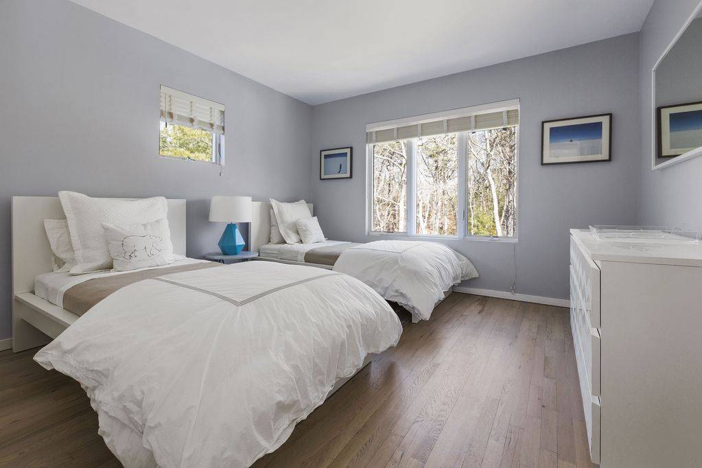165 2 Holes Water Road East Hampton, NY 11937 - Photo 11 of 19 a bedroom with two beds and a window