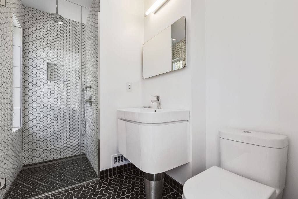 165 2 Holes Water Road East Hampton, NY 11937 - Photo 12 of 19 a bathroom with a sink toilet and shower