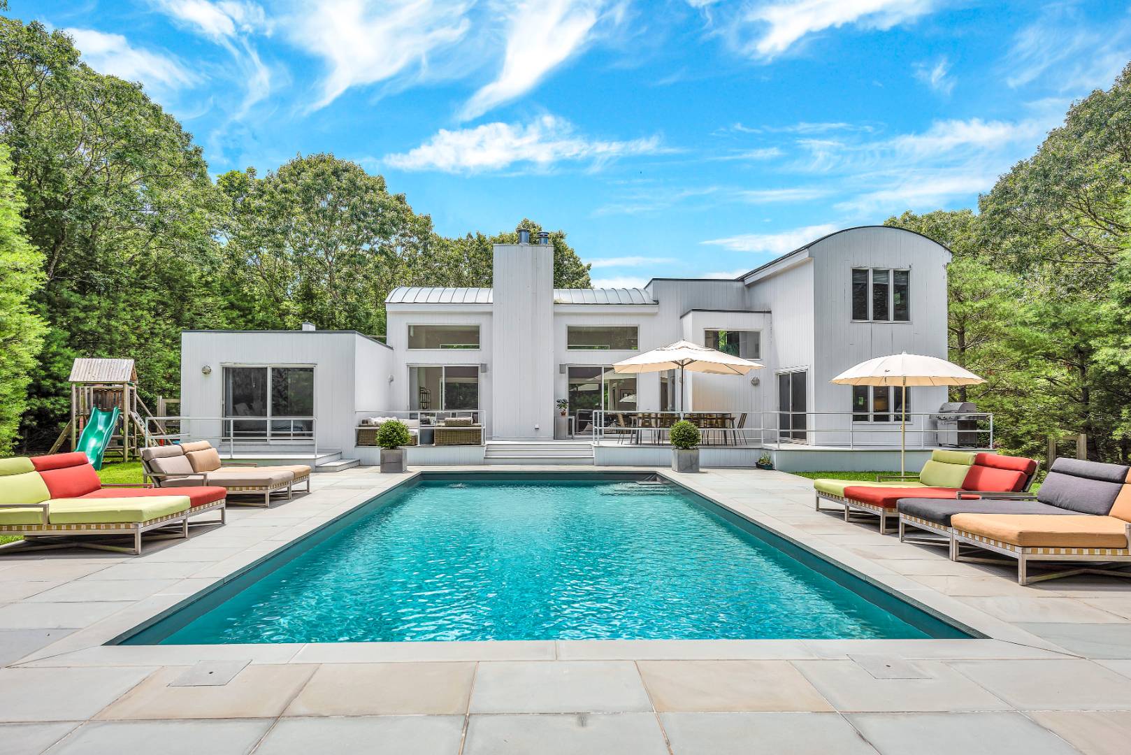 165 2 Holes Water Road East Hampton, NY 11937 - Photo 18 of 19 a swimming pool view with a seating space and a garden view