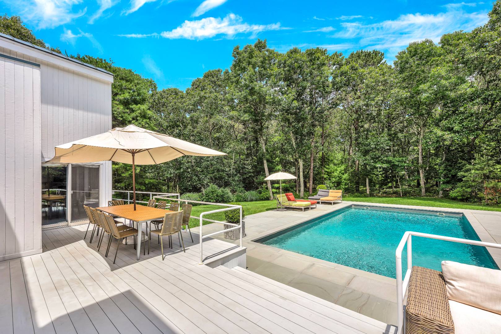 165 2 Holes Water Road East Hampton, NY 11937 - Photo 3 of 19 a view of a patio with swimming pool table and chairs