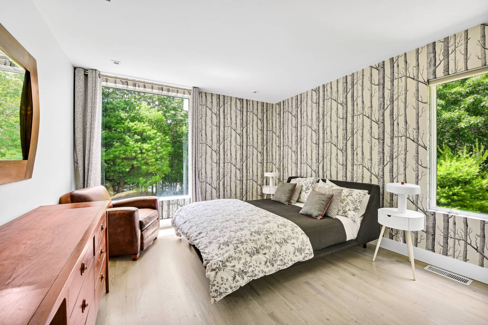 165 2 Holes Water Road East Hampton, NY 11937 - Photo 9 of 19 a bedroom with a bed lamp and a large window