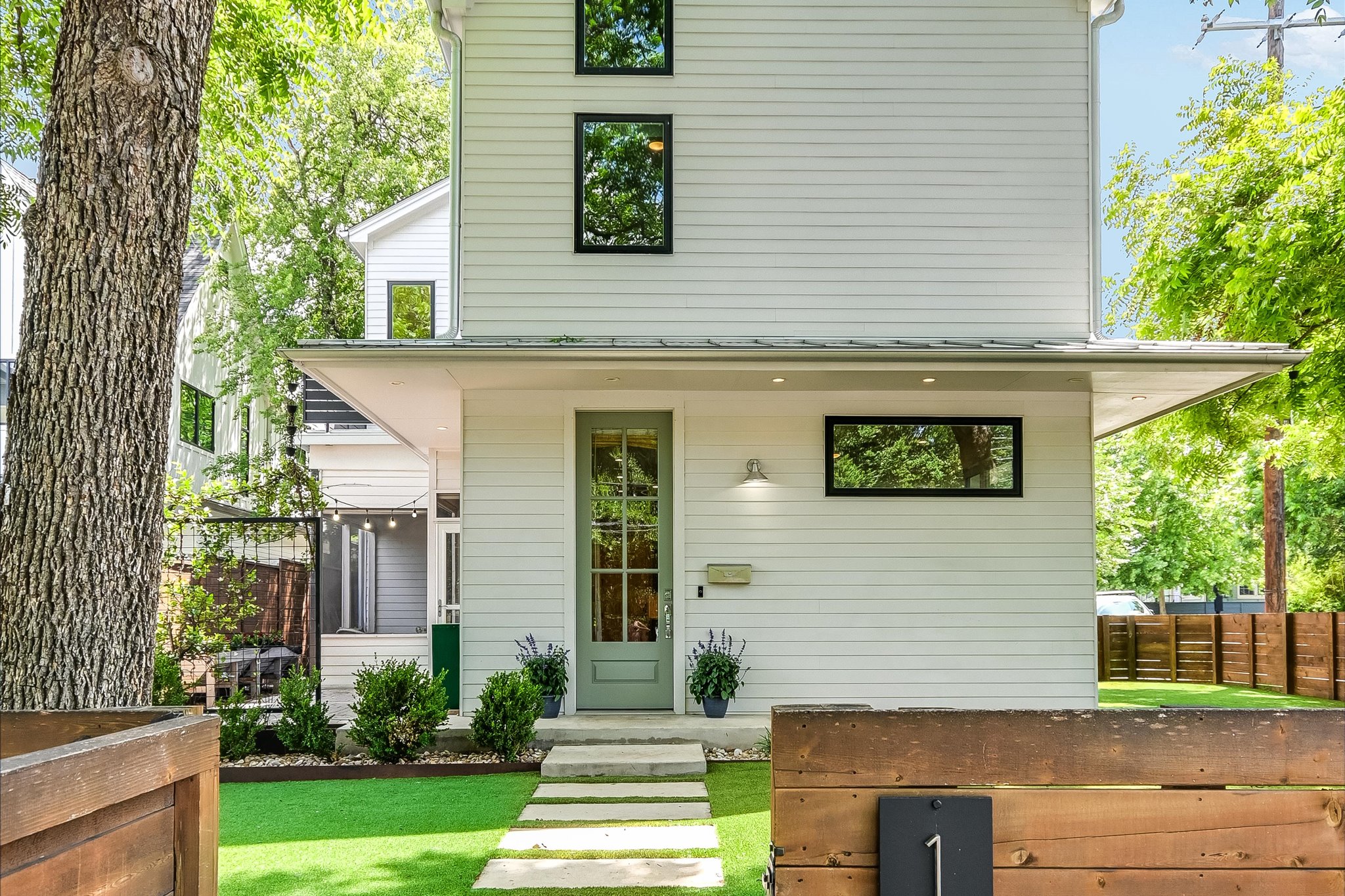 1605 Hether Street Austin, TX 78704 - Photo 2 of 26 Contemporary exterior featuring white horizontal siding and black-framed windows