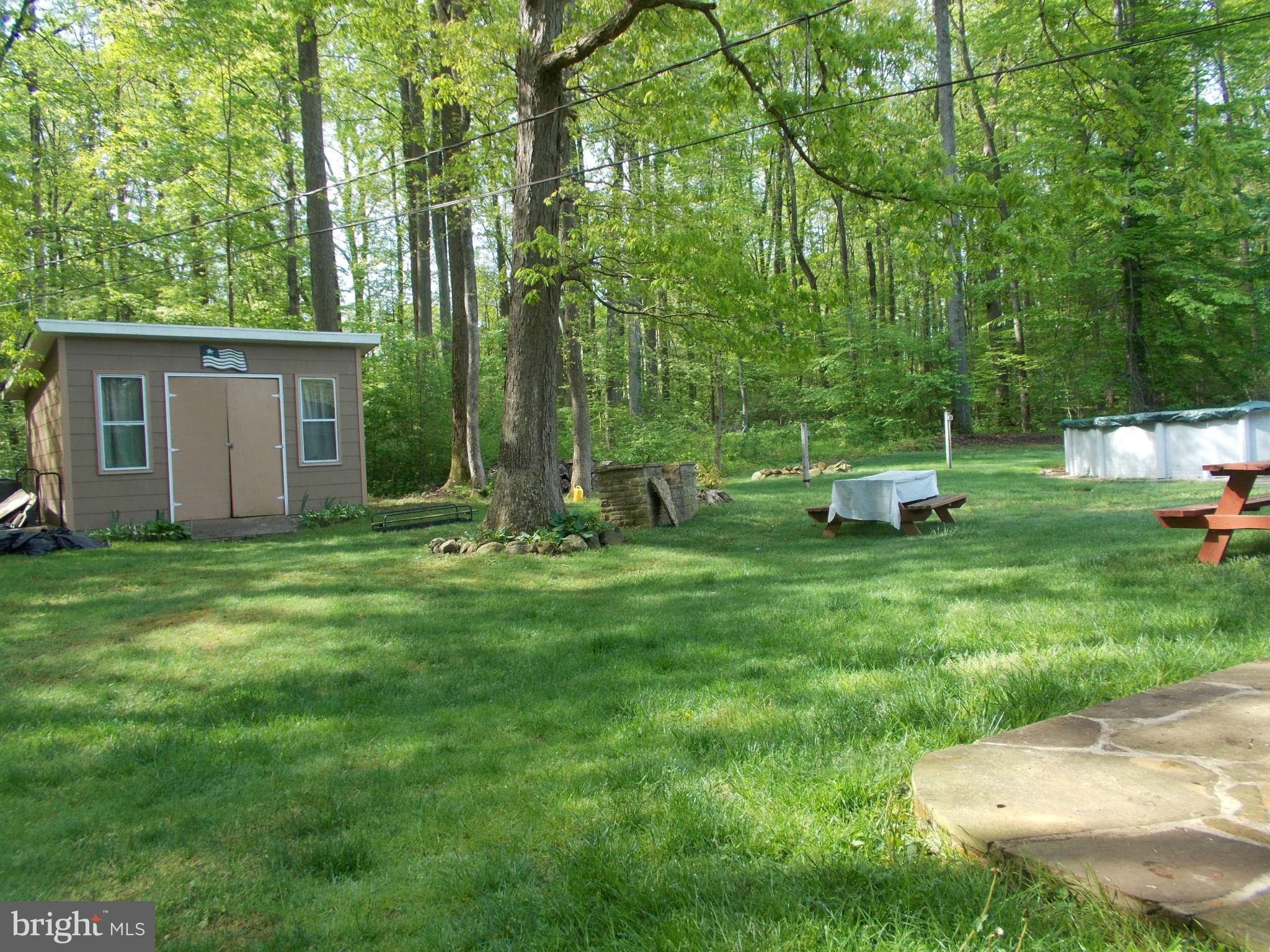 2419 Stoneybrook Road Fallston, MD 21047 - Photo 22 of 30 a view of backyard with outdoor seating and green space