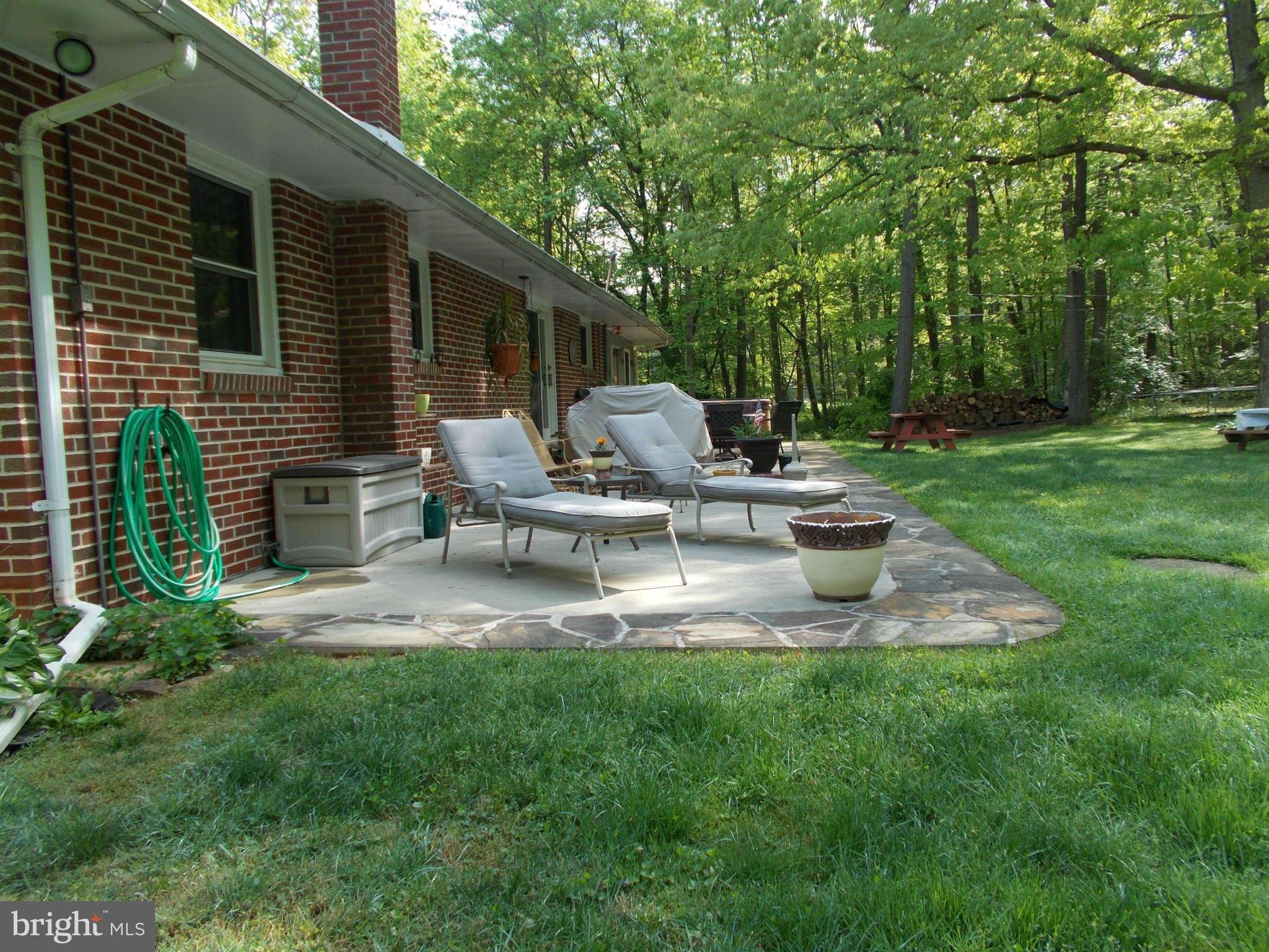 2419 Stoneybrook Road Fallston, MD 21047 - Photo 24 of 30 a view of a chair and table in the garden