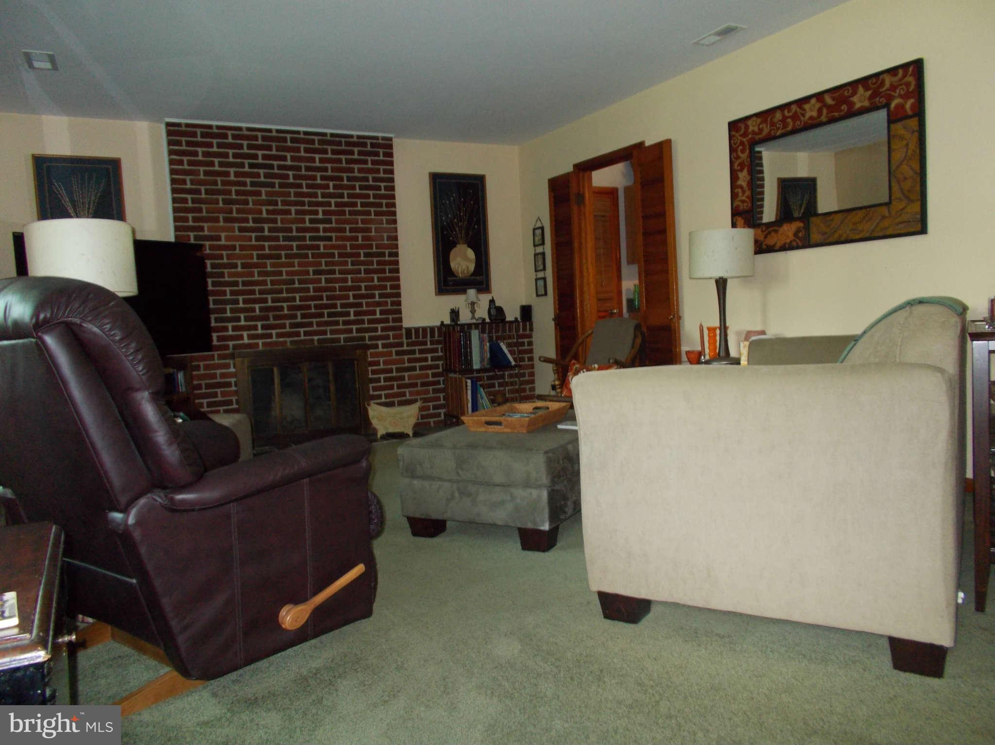2419 Stoneybrook Road Fallston, MD 21047 - Photo 4 of 30 a living room with furniture and a fireplace