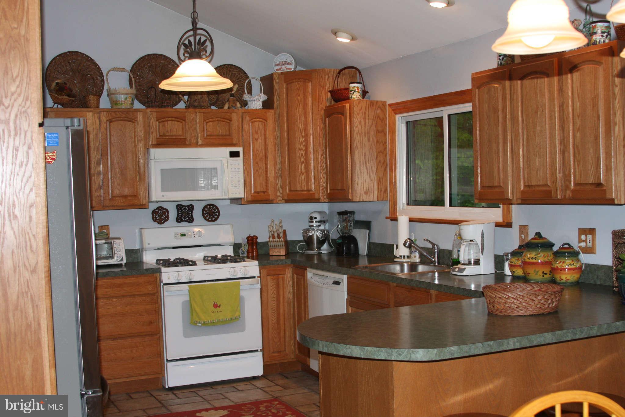 2419 Stoneybrook Road Fallston, MD 21047 - Photo 7 of 30 a kitchen with stainless steel appliances granite countertop a stove a sink dishwasher and cabinets with wooden floor