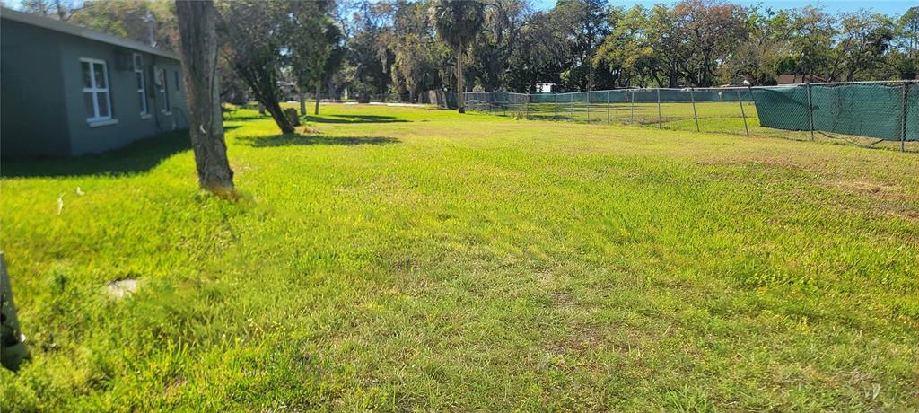 14101 Plum Lane Hudson, FL 34667 - Photo 2 of 2 a view of a swimming pool with a yard and large trees
