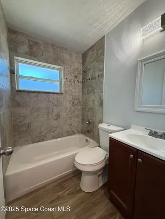 a bathroom with a sink a toilet and a bathtub