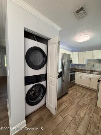 a kitchen with a washer and dryer in it