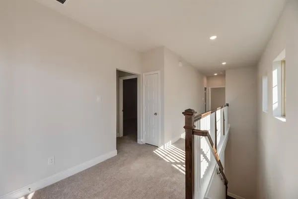 a view of a hallway with a room