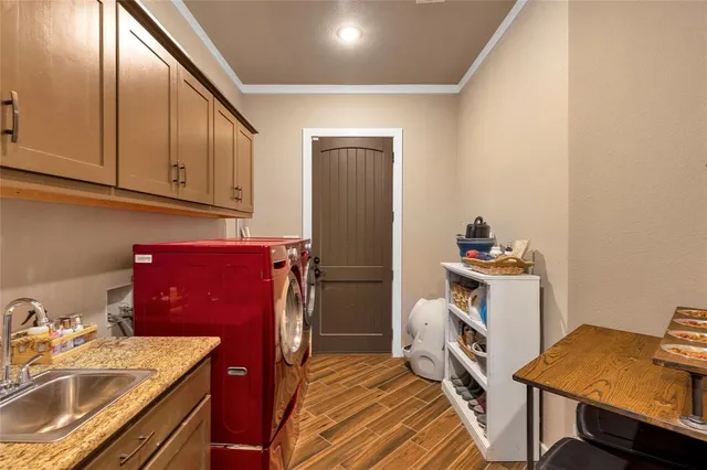a kitchen with a sink appliances and cabinets