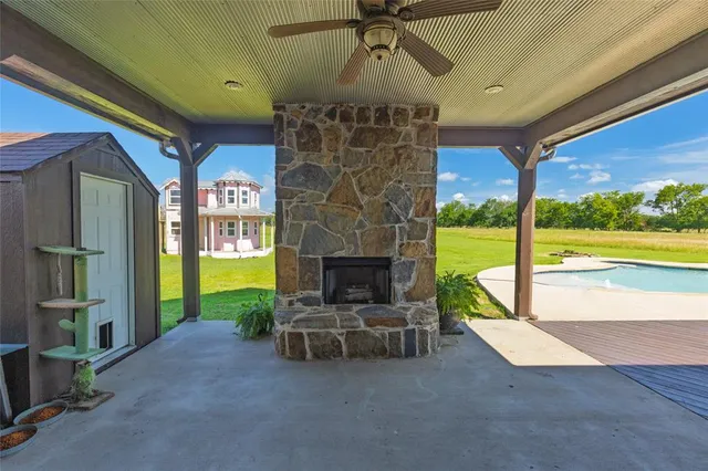 a living room with furniture a flat screen tv and a floor to ceiling window