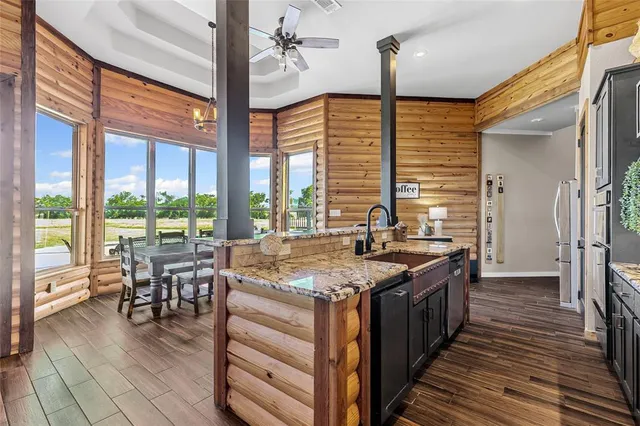 a kitchen with stainless steel appliances granite countertop sink stove and wooden floor