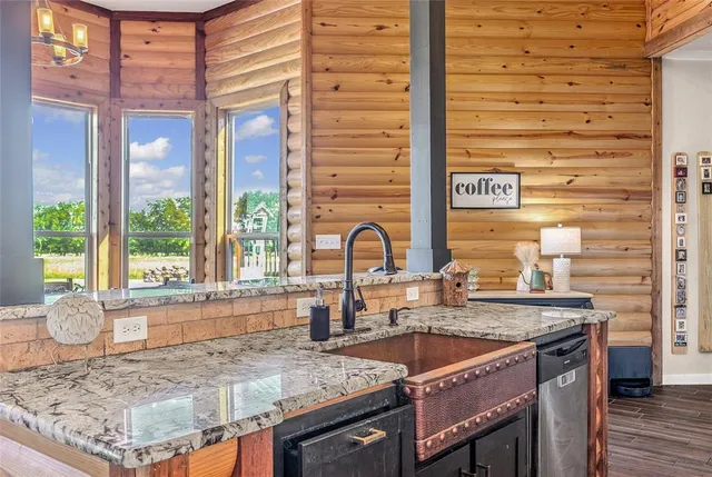 a kitchen with granite countertop a sink and a window