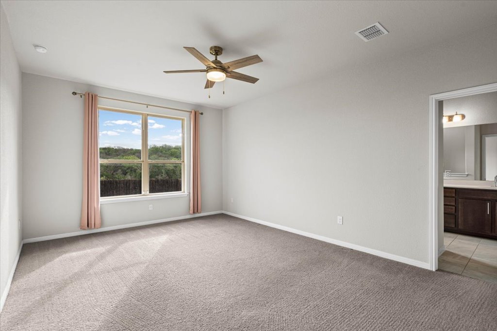1012 Goldilocks Lane Manchaca, TX 78652 - Photo 12 of 38 Large primary bedroom overlooking the backyard.
