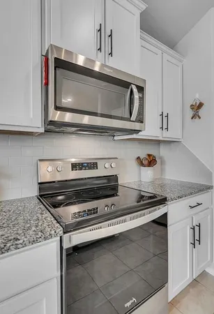 a stove top oven sitting inside of a kitchen