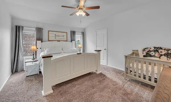 a living room with furniture and a baby crib