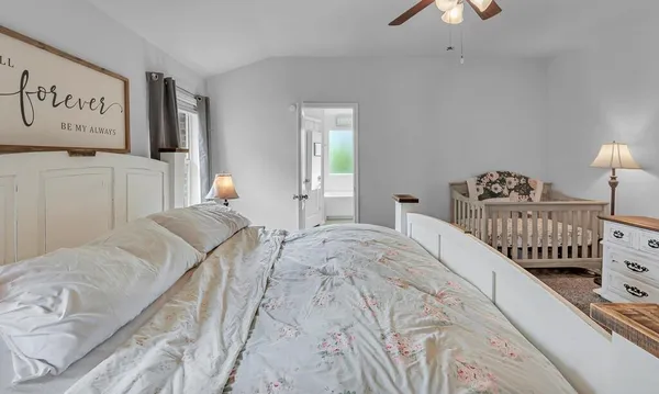 a bedroom with bed and window