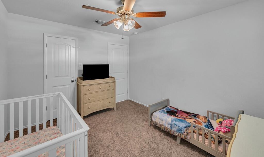 11108 Beckon Falls Waco, TX 76708 - Photo 23 of 32 a living room with a baby crib furniture and a flat screen tv
