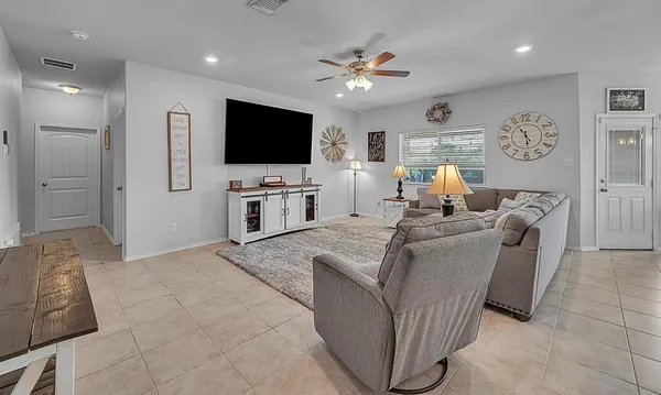 a living room with furniture and a flat screen tv
