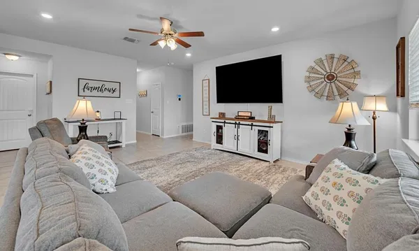 a living room with furniture and a flat screen tv
