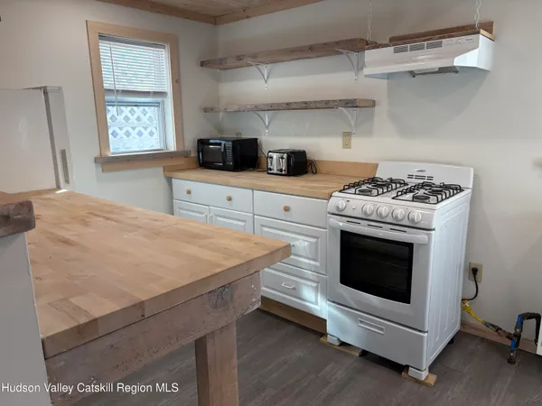 a kitchen with stainless steel appliances white cabinets and a stove