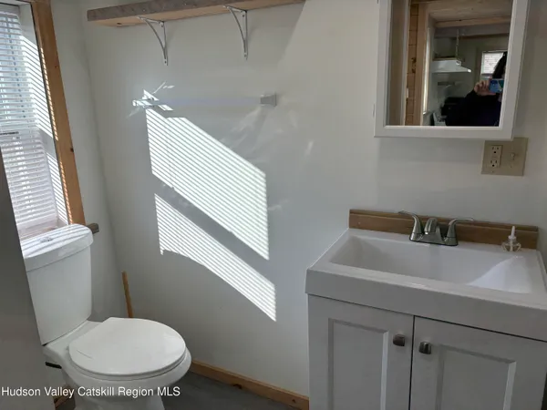 a bathroom with a toilet sink and mirror