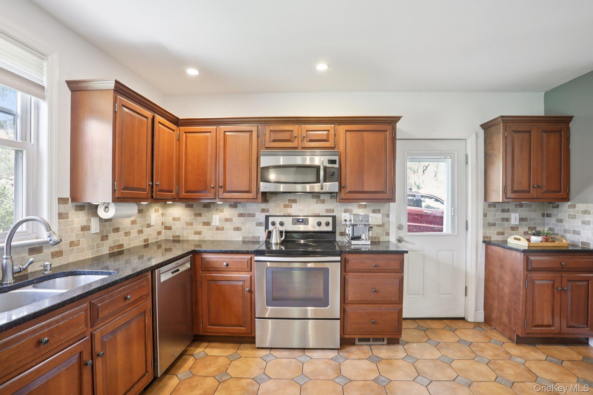101 Spring Valley Road Ossining, NY 10562 - Photo 18 of 39 a kitchen with stainless steel appliances a stove sink and cabinets