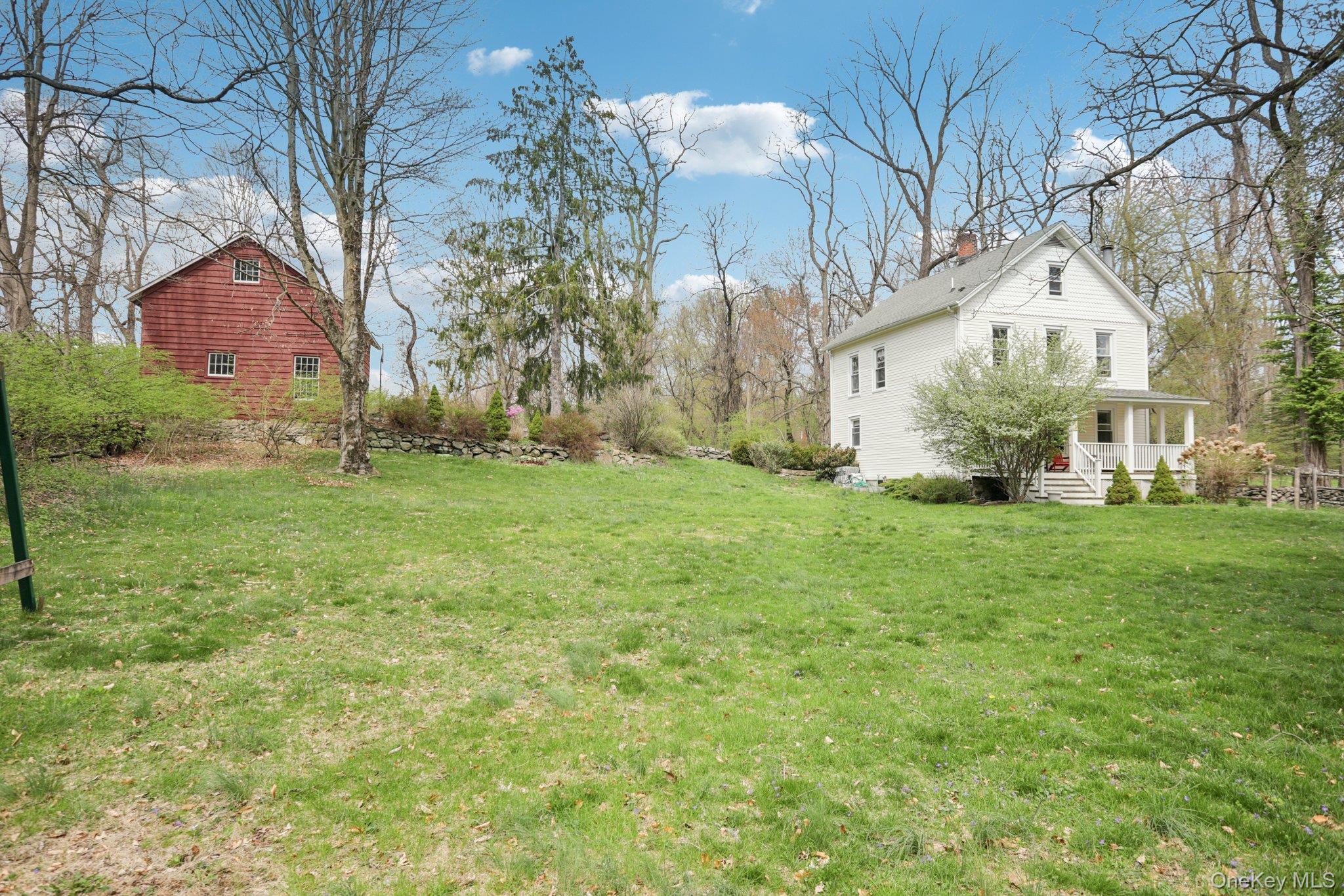 101 Spring Valley Road Ossining, NY 10562 - Photo 3 of 39 a view of a white house with a big yard and large trees