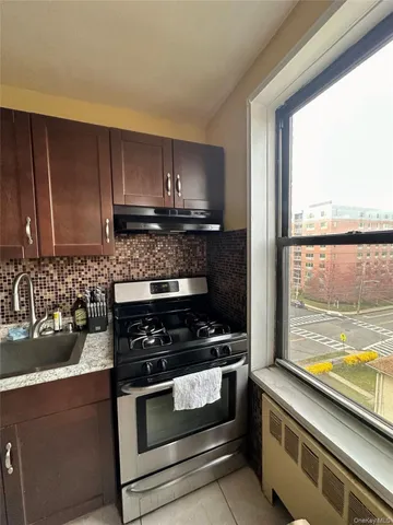 a kitchen with a sink a stove and cabinets