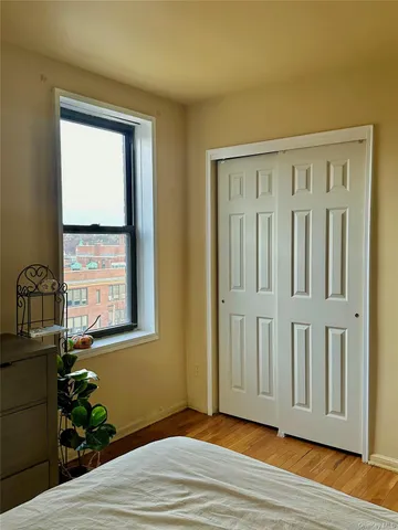 a view of a livingroom with wooden floor and a window