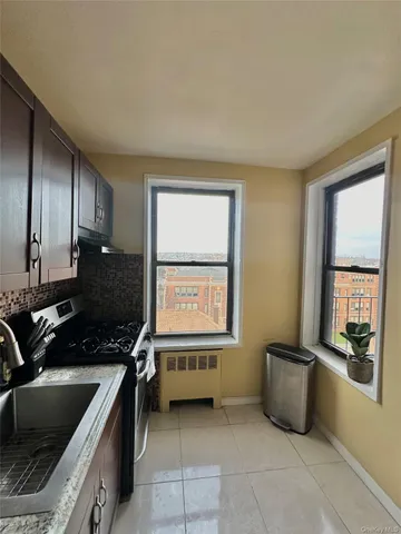 a kitchen with a sink and a stove top oven