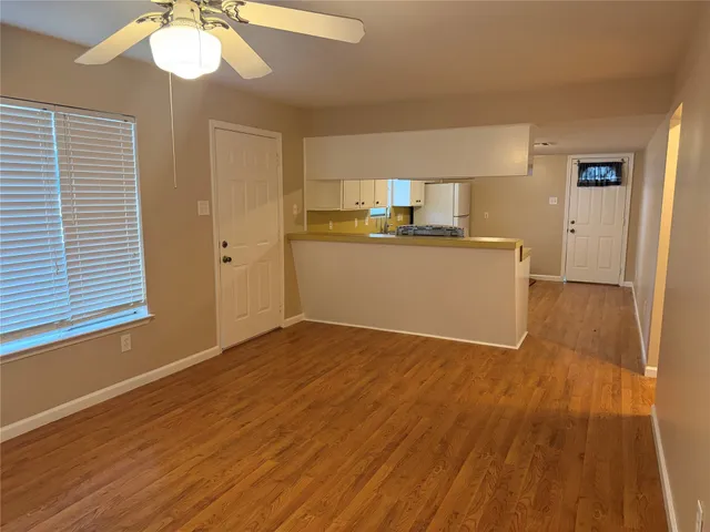 a room with wooden floor and white walls