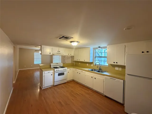 a kitchen with a sink stove and refrigerator
