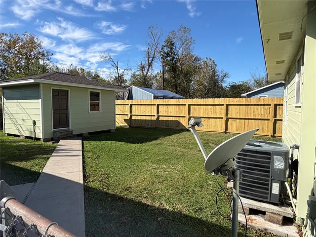 a view of backyard with wooden fence
