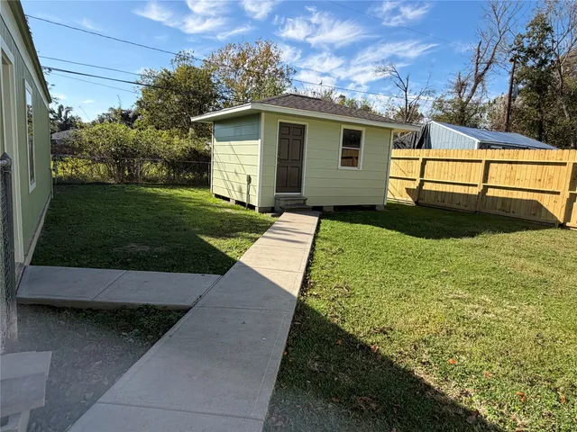 a view of backyard with outdoor seating and green space