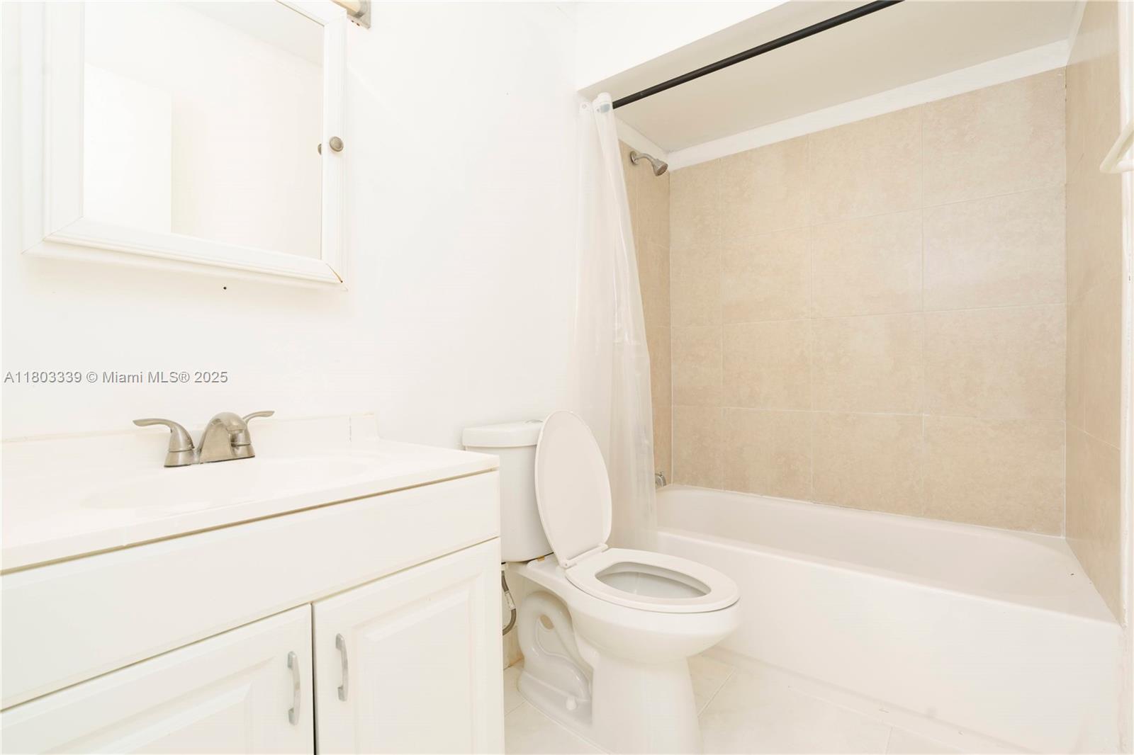 611 North University Drive, Unit 3 Plantation, FL 33324 - Photo 11 of 23 a bathroom with a sink a toilet and shower
