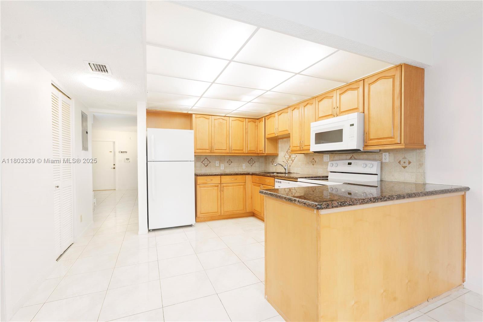 611 North University Drive, Unit 3 Plantation, FL 33324 - Photo 14 of 23 a kitchen with stainless steel appliances granite countertop a refrigerator a sink and a stove