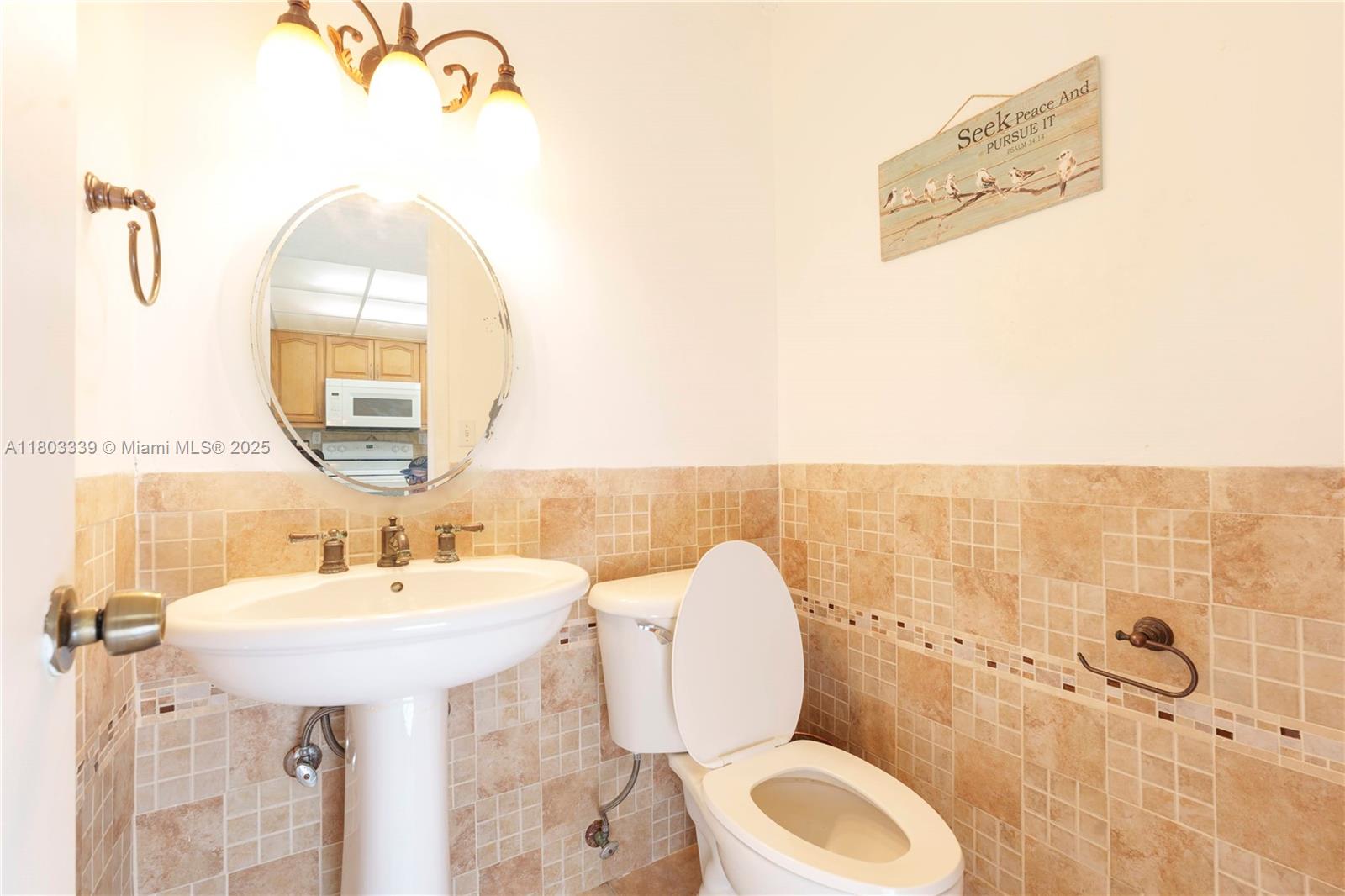 611 North University Drive, Unit 3 Plantation, FL 33324 - Photo 15 of 23 a bathroom with a toilet sink and mirror