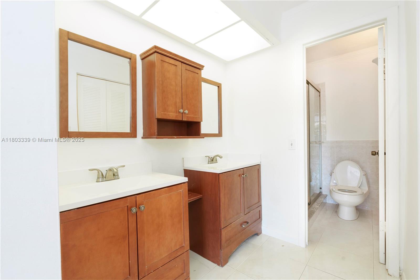 611 North University Drive, Unit 3 Plantation, FL 33324 - Photo 5 of 23 a bathroom with a sink a toilet and a mirror