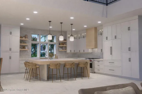 a kitchen with stainless steel appliances kitchen island granite countertop a table chairs sink and cabinets